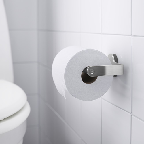 Portarrollos de papel higiénico blanco montado en la pared de azulejos blancos, que sostiene un rollo de papel higiénico, parte de la serie BROGRUND con tornillos ocultos.