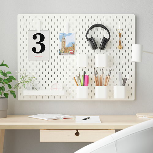 Organizador de tablero perforado SKÅDIS en blanco, de tamaño considerable para el espacio de trabajo, sujeta varios artículos de forma ordenada.