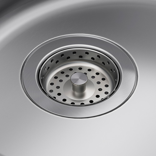 Colador de fregadero de acero inoxidable con diseño perforado y tapón central, que muestra calidad e higiene.