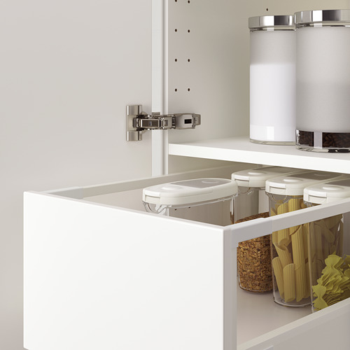 Mueble de cocina blanco con bisagras ajustables, que muestra la puerta de cierre lento con amortiguadores visibles.