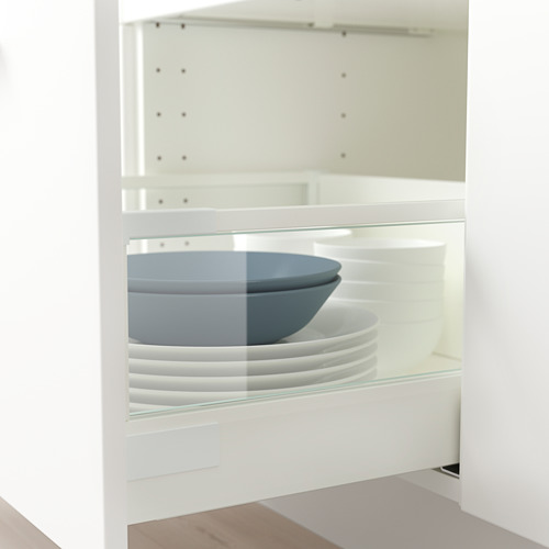 Armario blanco con cajón MAXIMERA con lados de vidrio, que contiene tazones y platos azules y blancos apilados, que muestran un almacenamiento organizado.