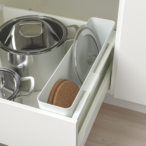 Cajón blanco con ollas, tapas y soportes de acero inoxidable organizados contra las manchas de HEAT.