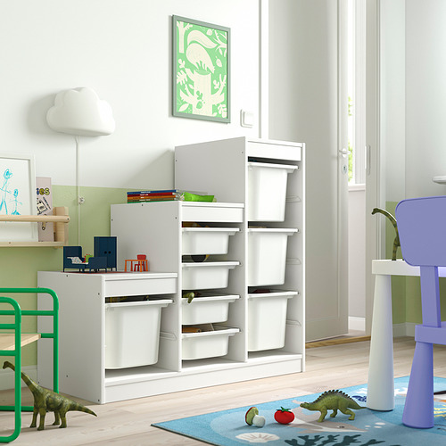 Habitación para niños con almacenamiento de juguetes TROFAST. Muebles modulares, blancos, con múltiples compartimentos, ideales para juguetes. Decoración luminosa y apta para niños con dinosaurios.