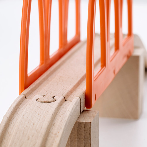 Primer plano de la vía del tren de madera de alta calidad con puente de plástico naranja, que muestra una artesanía duradera.