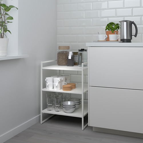 Small JONAXEL white metal shelf, neatly organizing kitchen items.