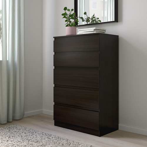 Cómoda KULLEN con 5 cajones, de pared, junto a cortinas, espejo con planta y libros encima.