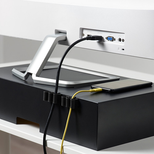 Los soportes de cable KALKSTUFF gestionan los cables en el escritorio, manteniéndolos organizados y accesibles.