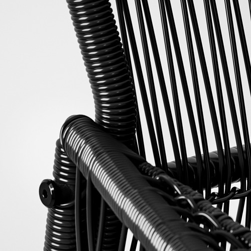 Silla de mimbre negro, tejido intrincado, estructura robusta.