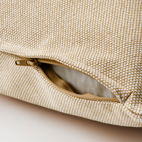 Cojín beige con tejido texturizado, cremallera abierta que deja ver el forro interior.