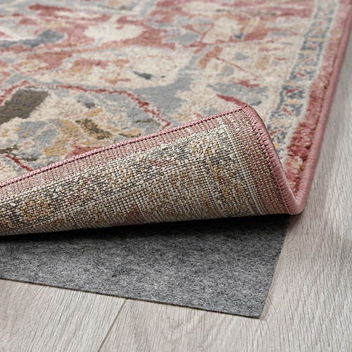 Alfombra de estilo oriental suave y pastel con material duradero y resistente a las manchas y respaldo antideslizante.