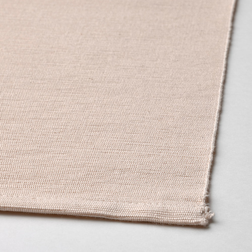 Primer plano de mantel individual beige tejido; Textura natural de algodón de alta calidad visible.