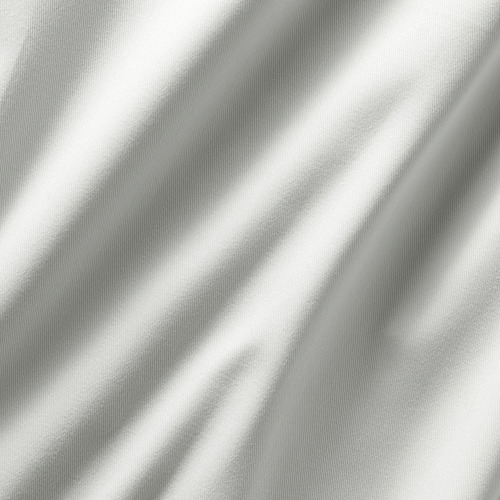 Primer plano de cortinas afelpadas y tenues con una intrincada textura de tejido, que muestra una tela de calidad.