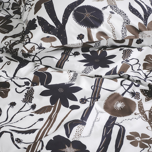 Juego de ropa de cama blanca con intrincados patrones florales y de hojas oscuras. Estampado de alta calidad en tejido nítido y suave.