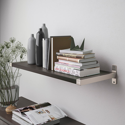 A modern wall shelf with a sleek design holds various books and decorative vases, showcasing its functionality for organizing and displaying items.