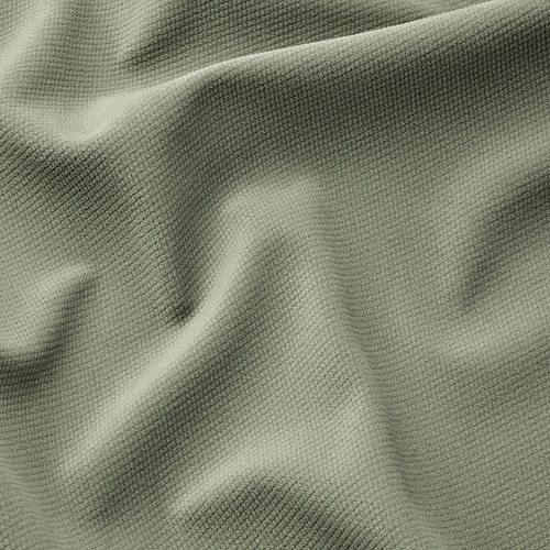 Un primer plano de una tela verde suave y texturizada, posiblemente de un cojín o funda de muebles EKTORP, enfatizando su textura suave y acogedora.