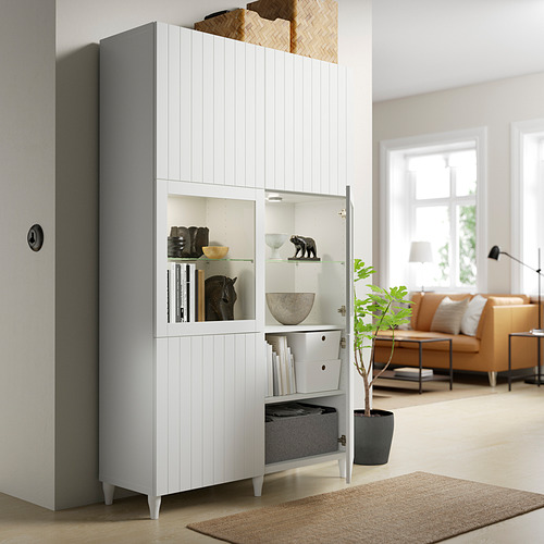 Modern living room with white BESTÅ cabinet showing storage and display combo, books, and decor.