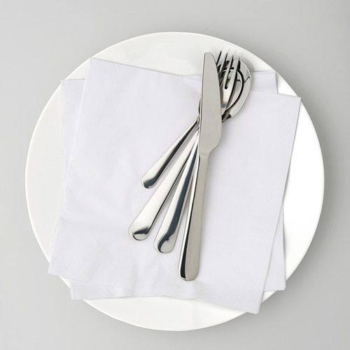 Plato blanco redondo que sostiene una servilleta blanca doblada con un cuchillo brillante, tenedor y cuchara en la parte superior.