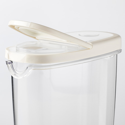 Tarro de plástico transparente para alimentos con tapa blanca abatible, diseñado para el almacenamiento de alimentos secos. Transparente para facilitar la visibilidad.