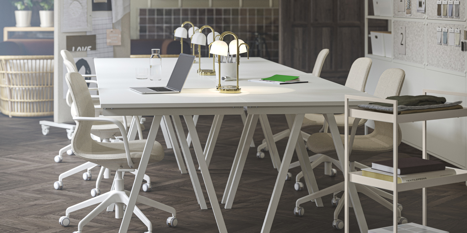 An updated office space with four white TROTTEN desks grouped together, paired with beige/white LÅNGFJÄLL conference chairs.