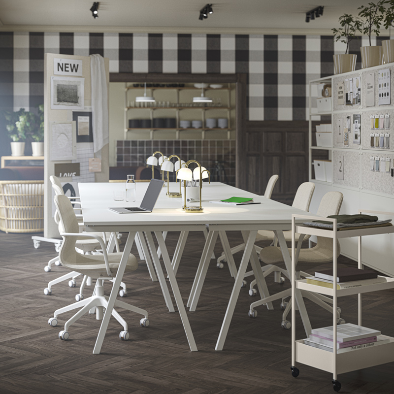 An updated office space with four white TROTTEN desks grouped together, paired with beige/white LÅNGFJÄLL conference chairs.
