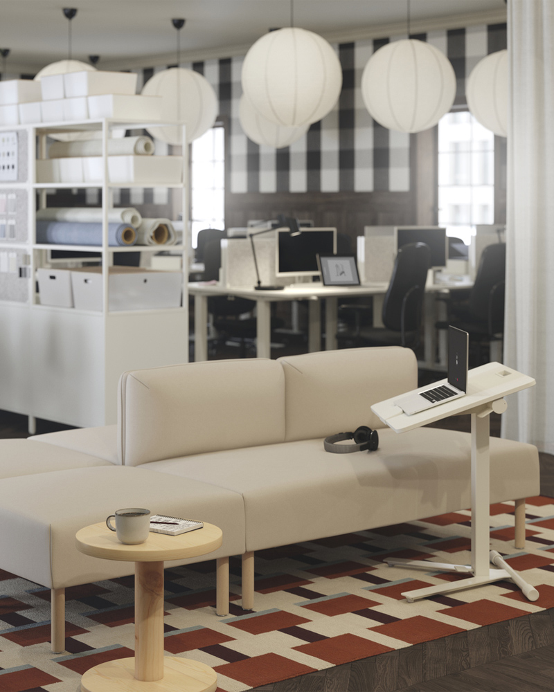 A beige LILLEHEM modular sofa with wooden legs, paired with a white MITTZON laptop table, set on a geometric patterned rug.