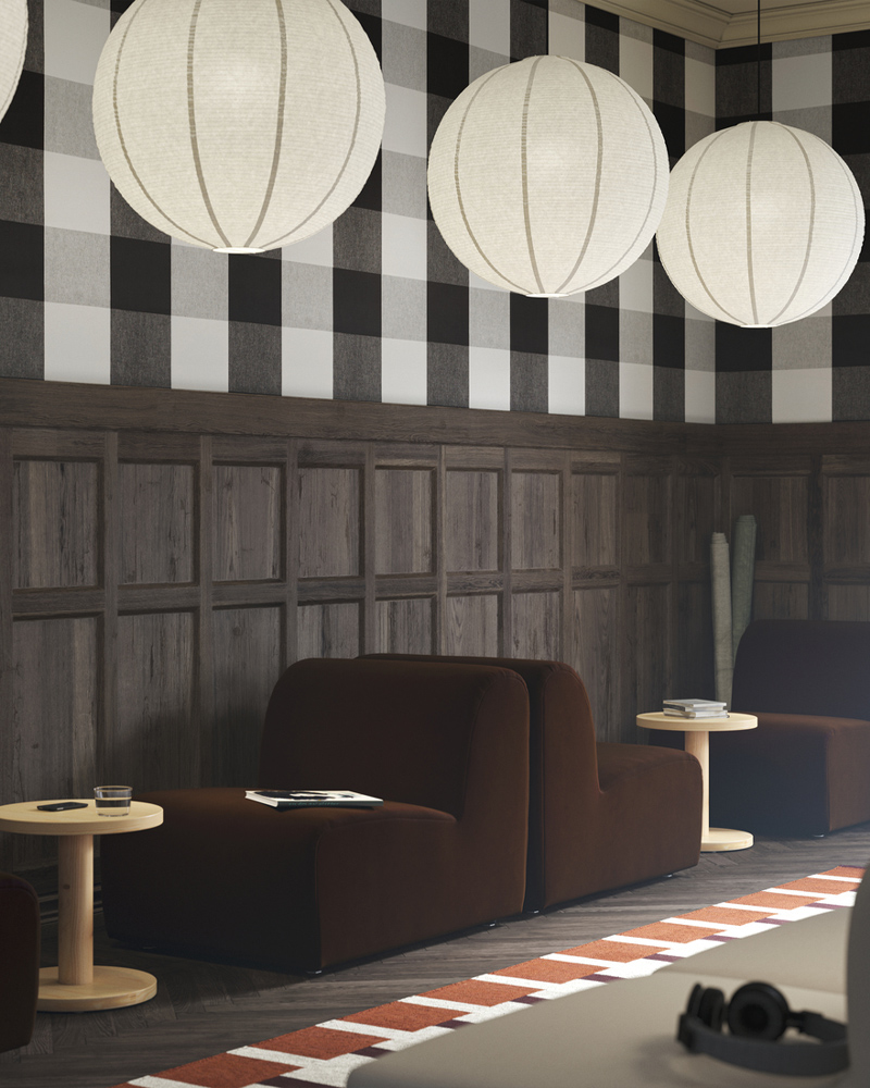 Two dark brown STOCKHOLM seats, paired with pine side tables, with GULLSUDARE pendant lamps hanging from the ceiling.
