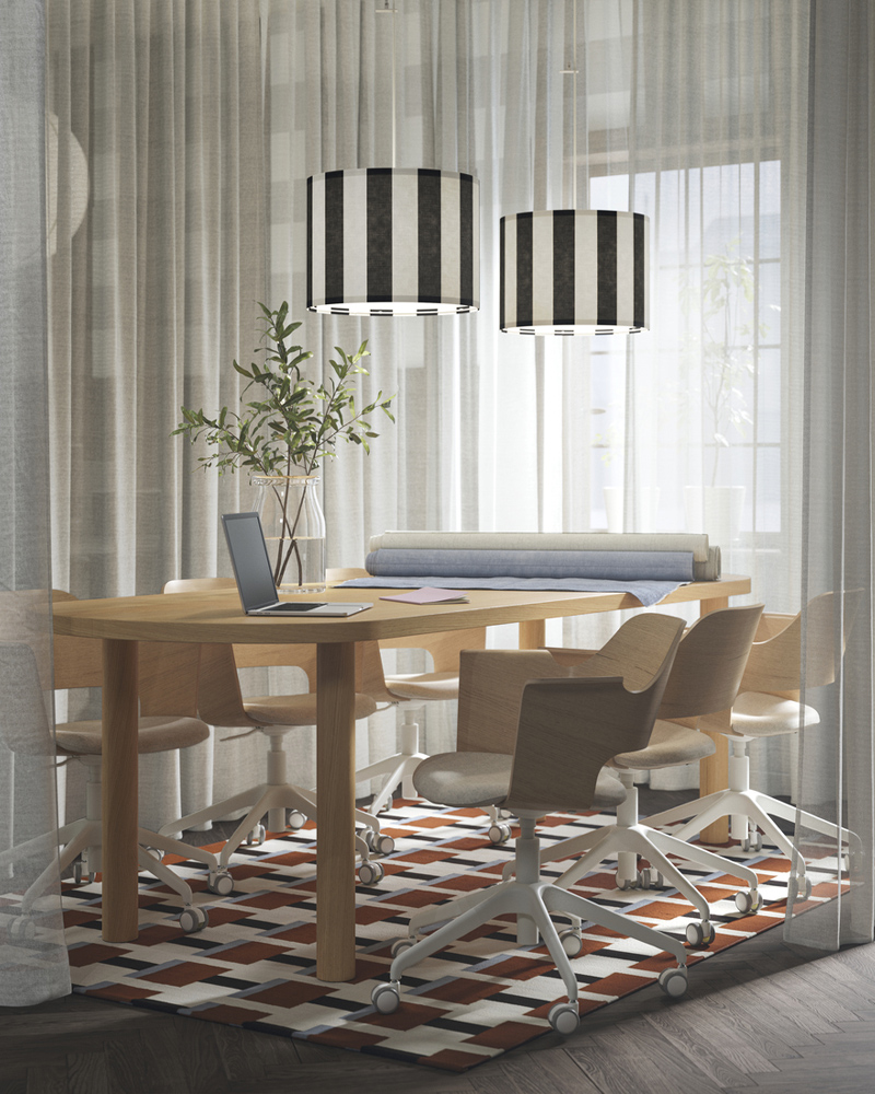 A meeting space with white ÄNGSFRYLE sheer curtains, an oak veneer STOCKHOLM table, and padded conference chairs around it.