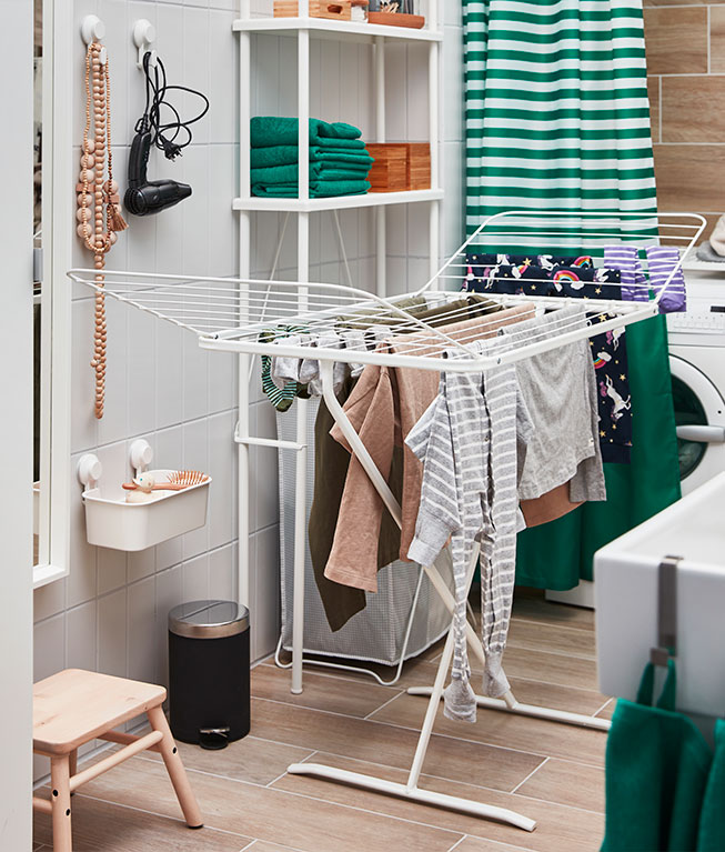 MULIG Drying rack next to VILTO Step stool in a washing room