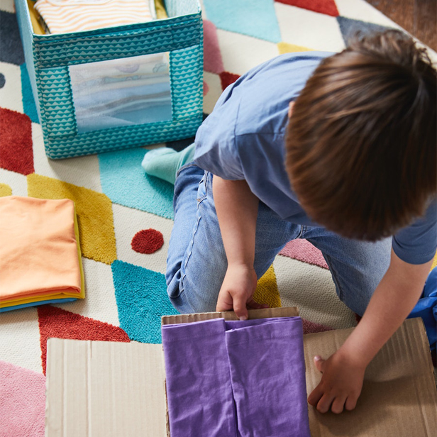 A child on a BUSENKEL rug