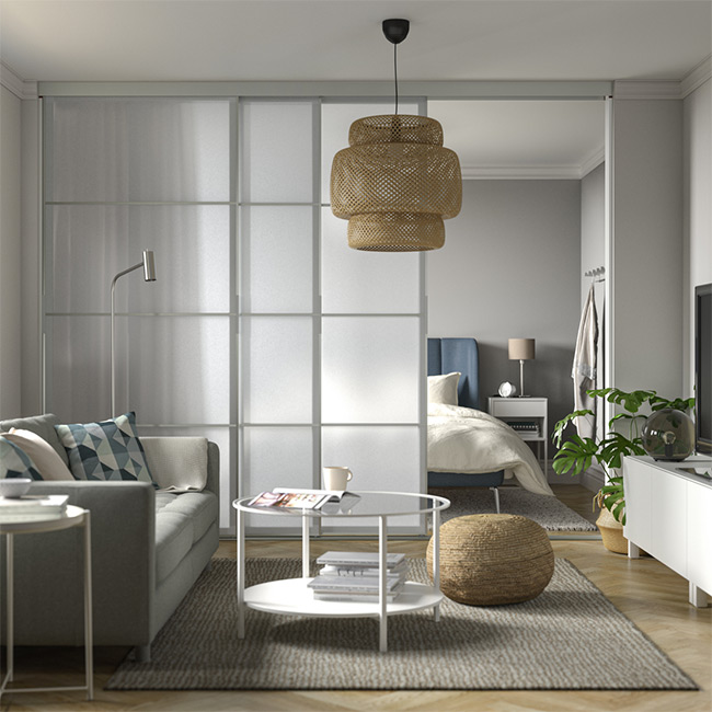 Living room separated from bedroom, frosted glass sliding doors, creating a bright, airy open plan.