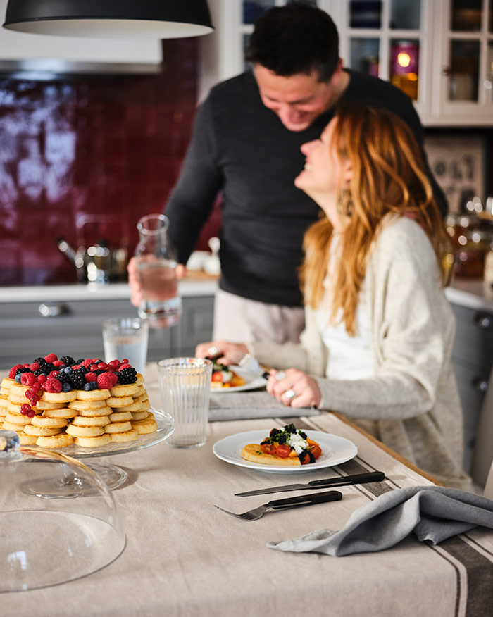A happy couple dinning at their kitchen