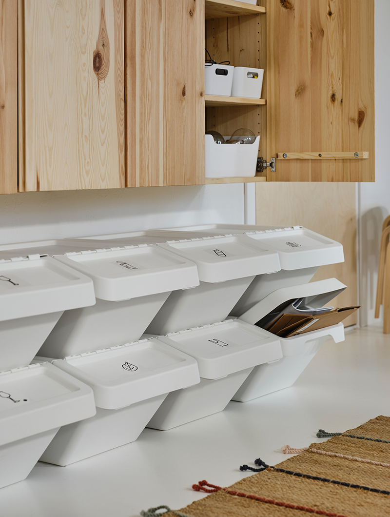 A wall cabinet with IVAR doors, several stacked SORTERA recycling bins, and a RAKLEV rug.