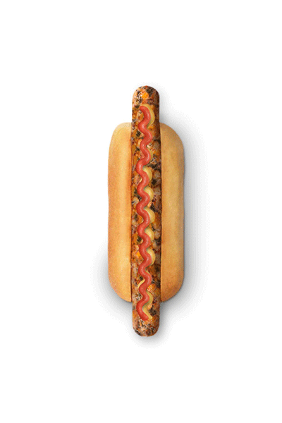Un perrito caliente vegetal con cereales y semillas visibles en pan tierno, aderezado con una línea ondulada de kétchup y mostaza.