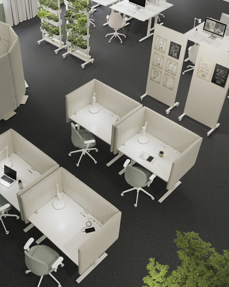 Top view of an office with several cubicles with desks and office chairs there are also bulletin boards with modern furniture wheels and planters the environment is creative and elegant.
