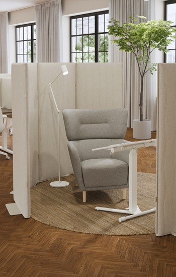 Office space with work desk and desk set up as a private cubicle