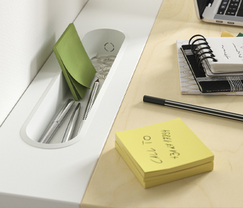 detail of a desk organizer space there are visible post its notepads clips and pens
