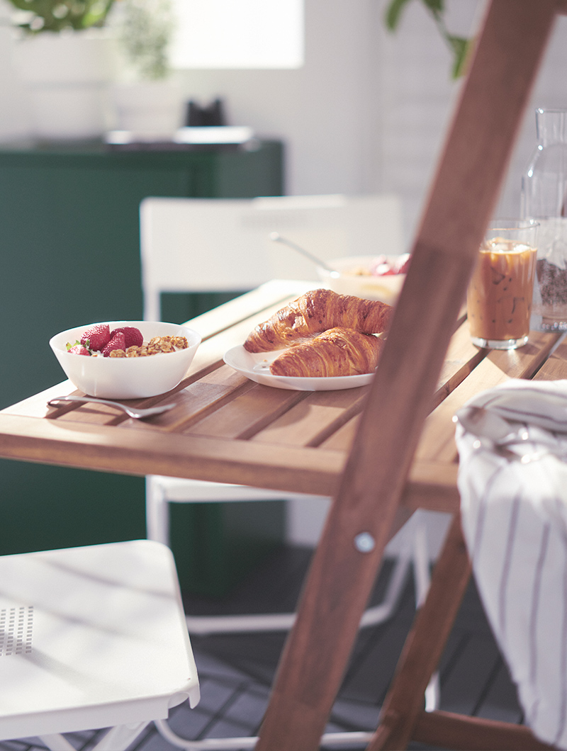 Detail of dinnerware with food served on an outdoor table