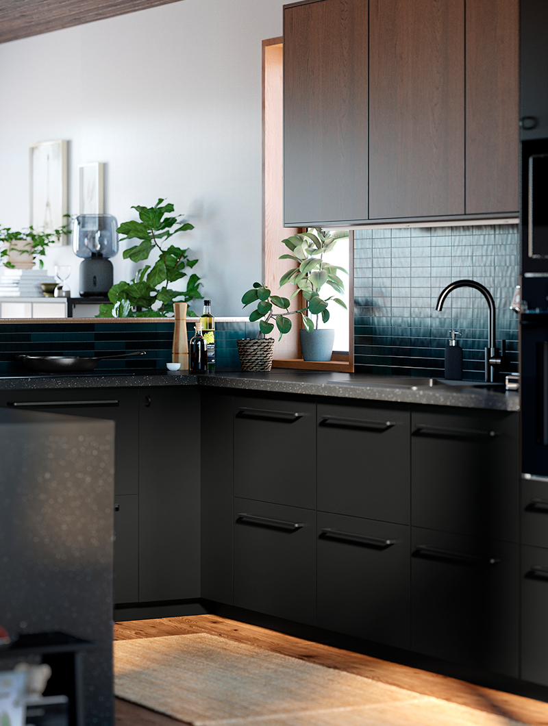 Modern kitchen with anthracite cabinets, blue tiles, and green plants, creating an elegant and natural ambiance.