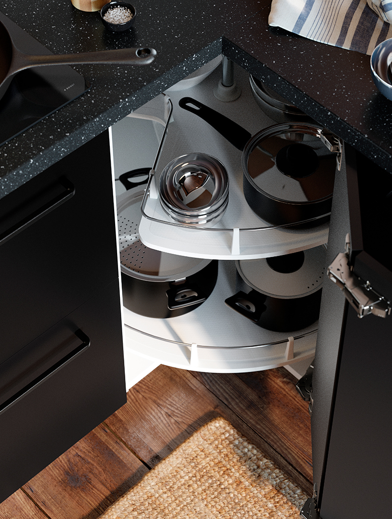 A dark corner kitchen cabinet with a white pull-out carousel full of pots and pans, maximizing storage