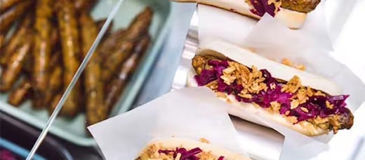 Tasty plant-based hot dogs with crispy onions and fresh veggies – perfect for a quick bite at IKEA.