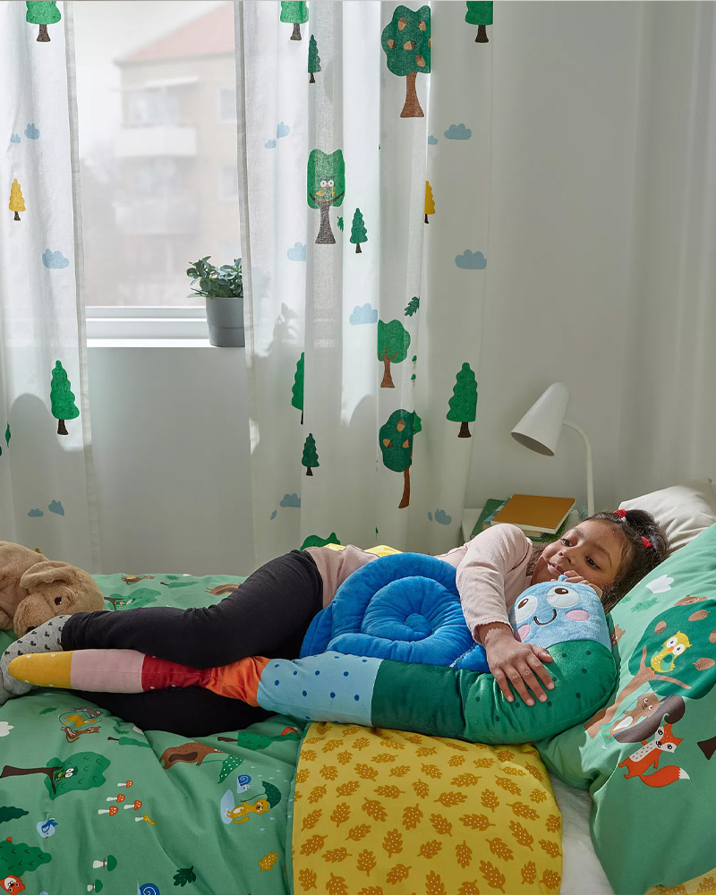 sleeping among softoys in bed