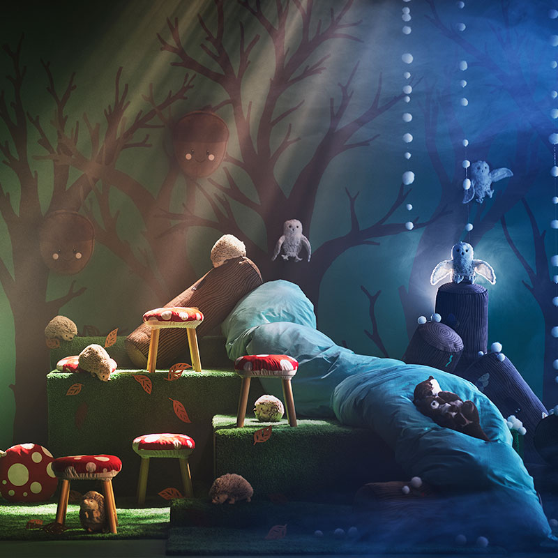 Stuffed animals and flowers in a magical lit forest. Fairy tale and nature atmosphere.