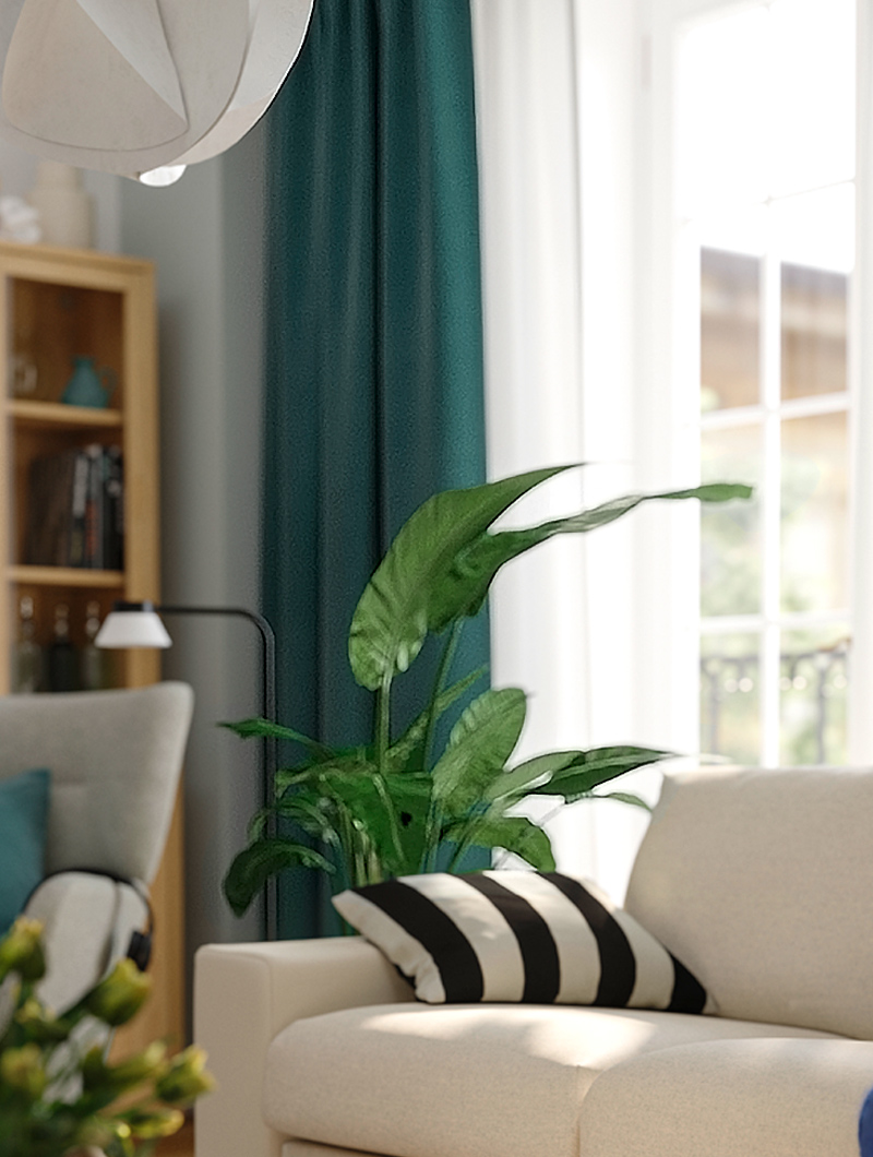 Un sofá KIVIK con una planta artificial FEJKA detrás en una sala de estar