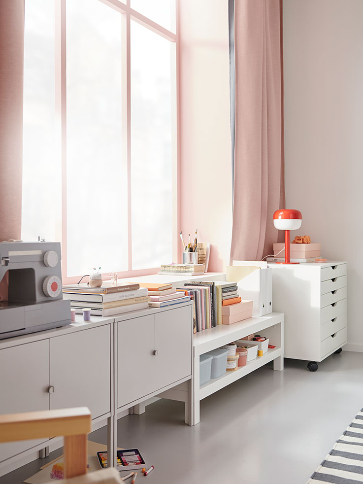 LIXHULT and ALEX storage solutions next to a LACK coffee table in a bedroom.