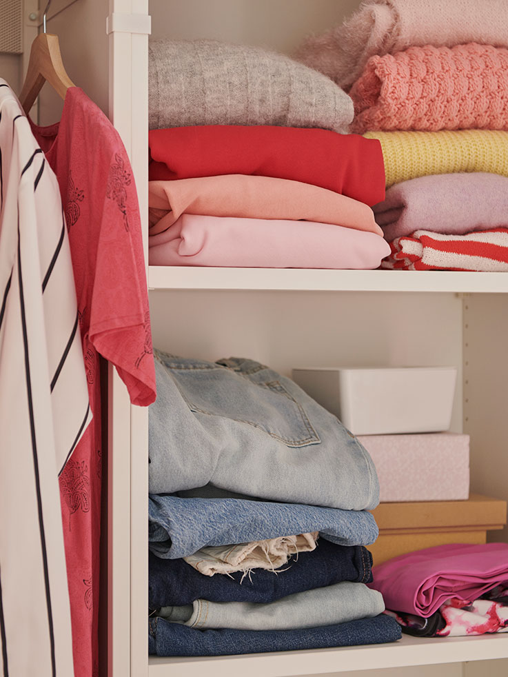 PLATSA wardrobe with clothes stored inside.
