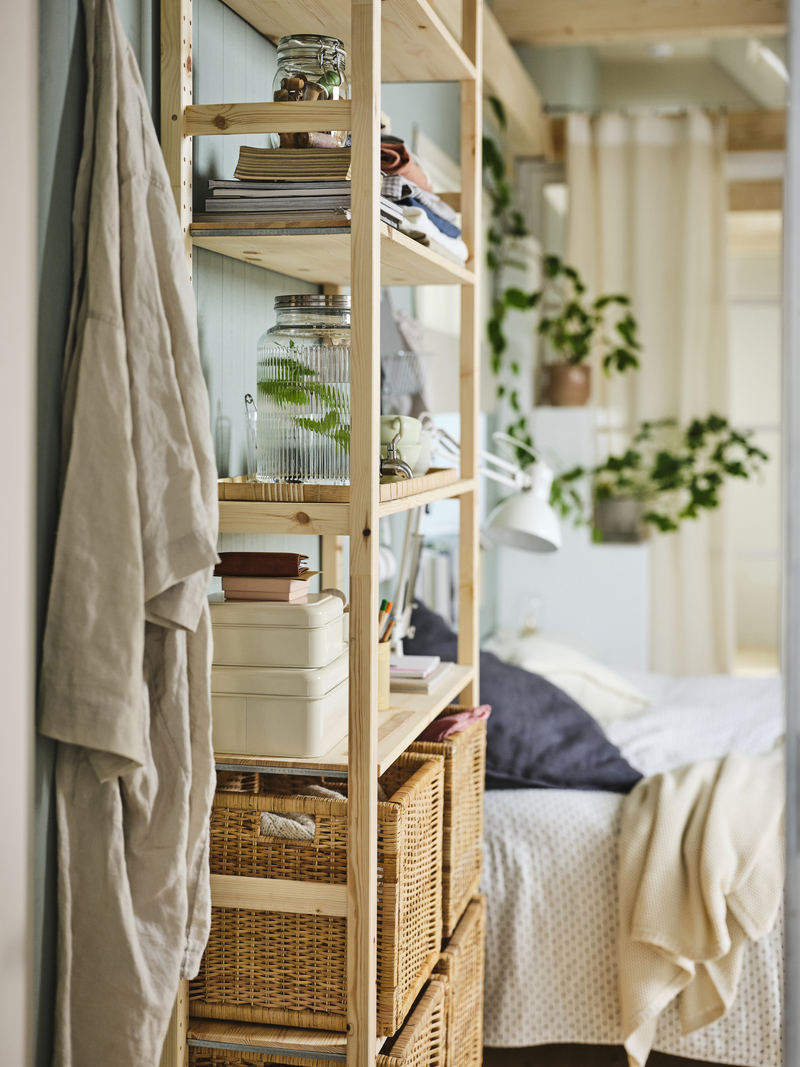 Beside the bed, an IVAR unit takes on bedside table duties