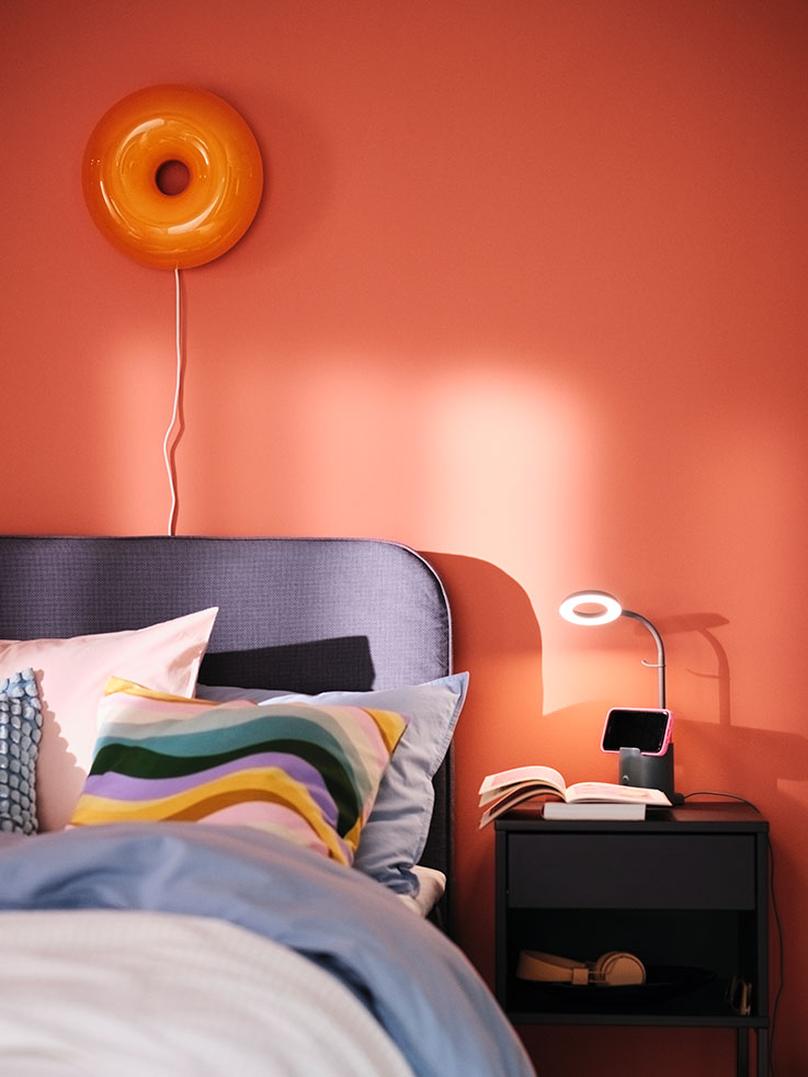 A VIKHAMMER nightstand next to a bed.