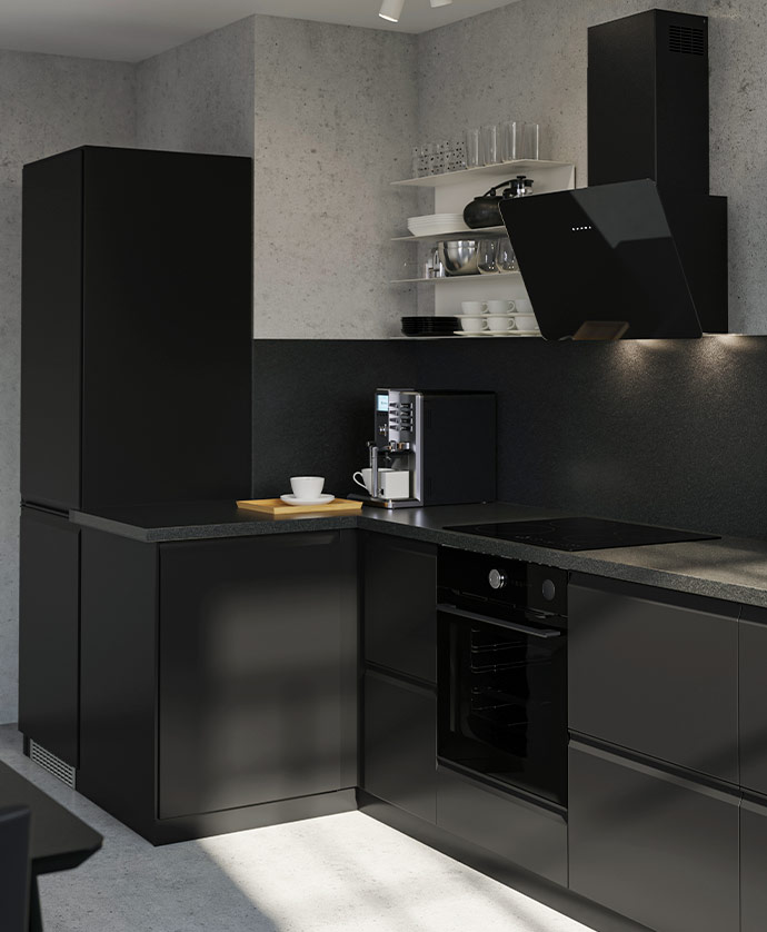L-shaped kitchen with black cabinets, dark countertop, automatic coffee machine, and shelves with tableware and glasses against a light grey wall.