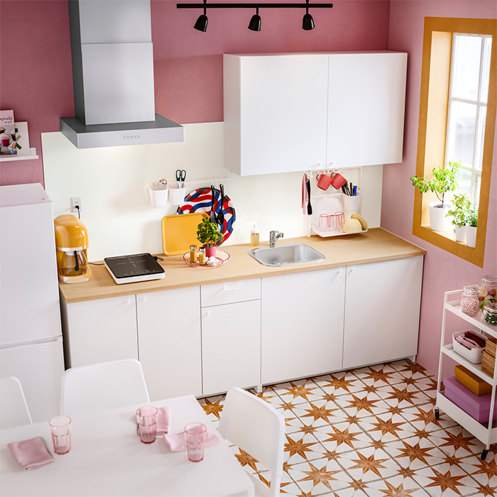 A warm, small kitchen with dining area in pastel tones