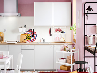 A warm, small kitchen with dining area in pastel tones